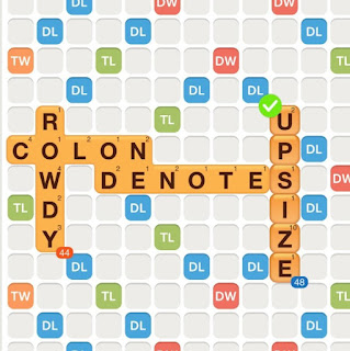 WWF game with the words colon, rowdy, and denote played on the board. The word "upsize" is added on the board, with the "s" used as a hook at the end of "denotes".